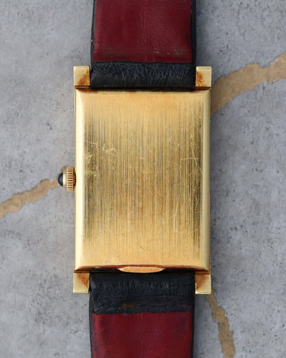 Rear view showing the solid 18K yellow gold case back.