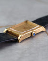 Side profile highlighting the crisp Clous de Paris finishing and blue cabochon crown.