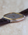 Close side view showing the yellow-gold bezel surrounded by the twisted white-gold outer case.