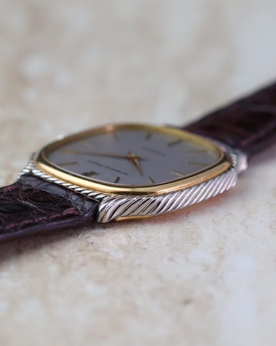 Close side view showing the yellow-gold bezel surrounded by the twisted white-gold outer case.