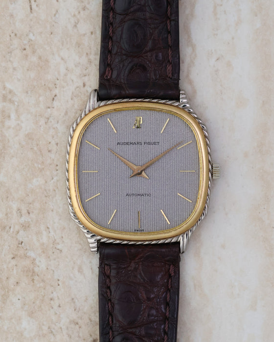 Front view of the Audemars Piguet automatic with textured silver dial, gold baton markers and applied AP monogram.