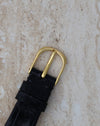 Reverse view of the matching Audemars Piguet gold buckle on its black leather strap.