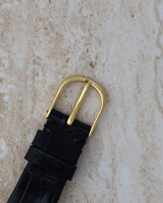Reverse view of the matching Audemars Piguet gold buckle on its black leather strap.