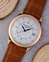 Angled front view showing the two-tone sector dial, date display and 18k rose gold case.