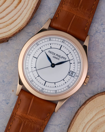 Angled front view showing the two-tone sector dial, date display and 18k rose gold case.