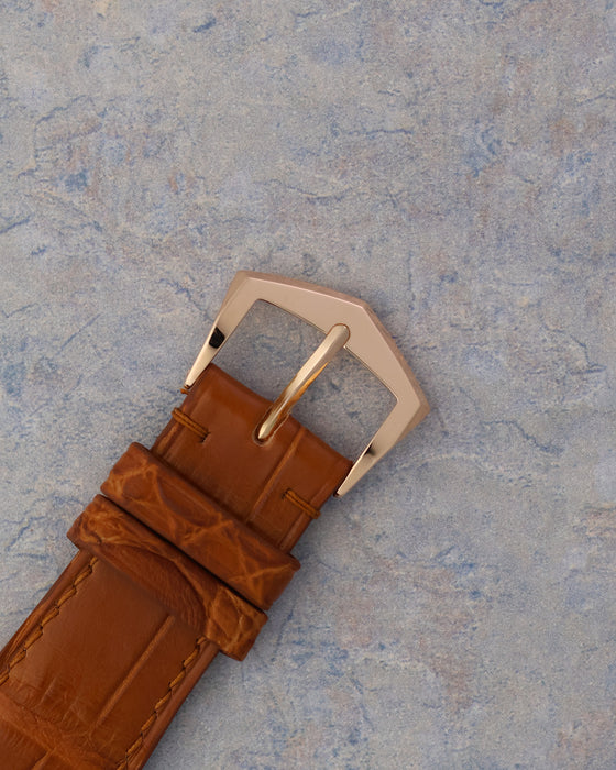 Original Patek Philippe 18k rose gold pin buckle fitted to the brown leather strap.