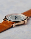 Angled view of the rose gold case, sector dial, blued hands and signed crown.