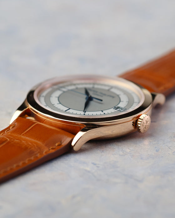 Angled view of the rose gold case, sector dial, blued hands and signed crown.