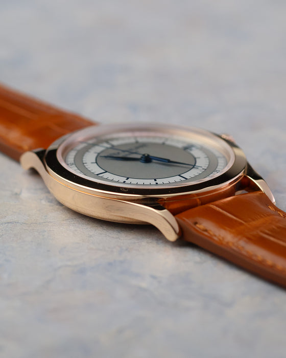 Side profile highlighting the polished bezel and flowing lug design of the 38mm rose gold case.