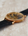 Original Universal Genève gold buckle fitted to the black leather strap.