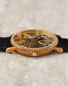 Low side profile highlighting the beaded bezel, fluted caseband and curved lugs.