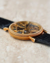 Angled profile showing the curved lugs and intricate case finishing.