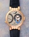 Front view of the Harry Winston Premier Excenter Time Zone in 18K rose gold with asymmetric dual-time dial.
