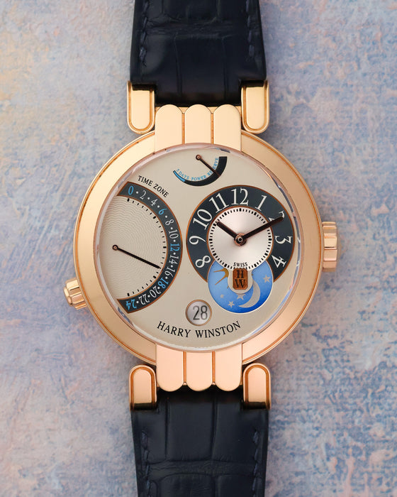 Front view of the Harry Winston Premier Excenter Time Zone in 18K rose gold with asymmetric dual-time dial.