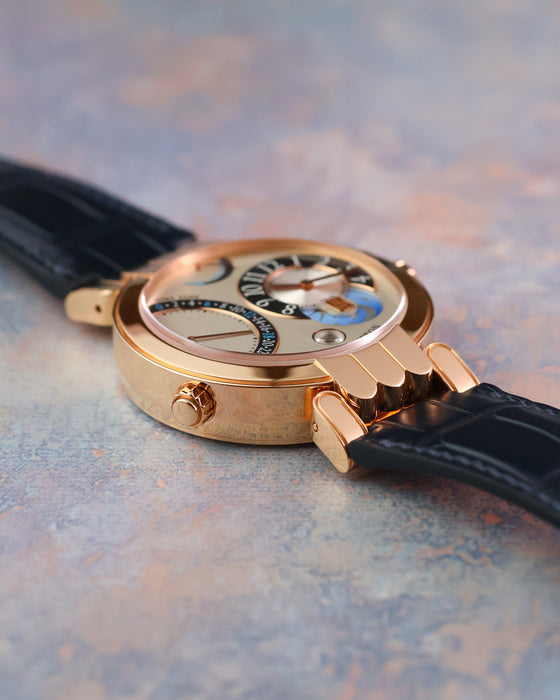 Side profile showing the polished rose gold case, articulated lugs and second-time-zone corrector.