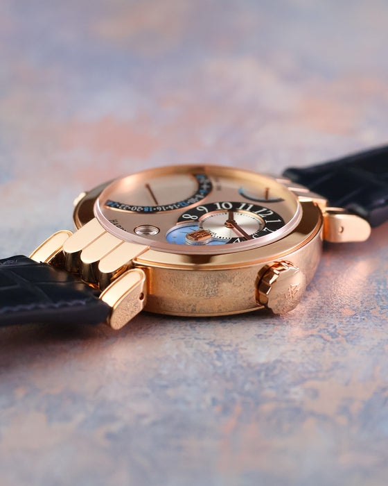 Low side profile of the Harry Winston Excenter Time Zone showing its curved crystal and rose gold case.