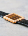 Low-angle view of the Piaget Protocole showing the thin rectangular yellow gold case and concealed lug construction.