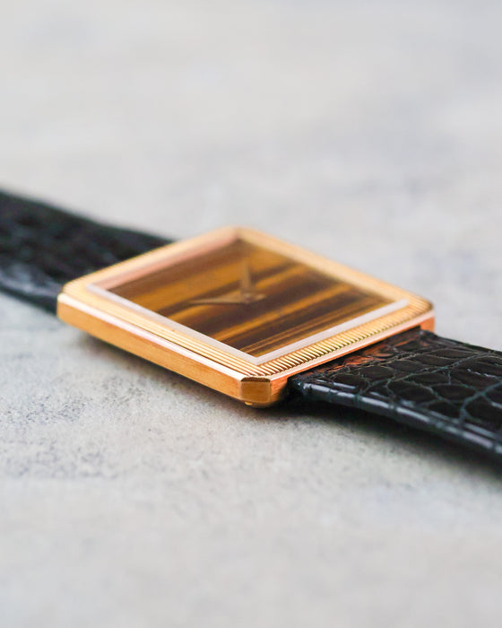 Low-angle view of the Piaget Protocole showing the thin rectangular yellow gold case and concealed lug construction.