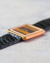 Side profile of the Piaget Protocole Ref. 9154 showing its slim 18K yellow gold case, reeded bezel and tiger’s eye dial.