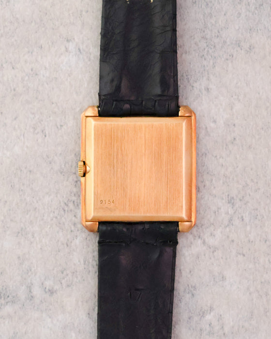 Caseback of the 18K yellow gold Piaget Protocole Ref. 9154 on its original black strap.