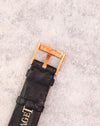 Original Piaget 18K yellow gold pin buckle fitted to the black leather strap.