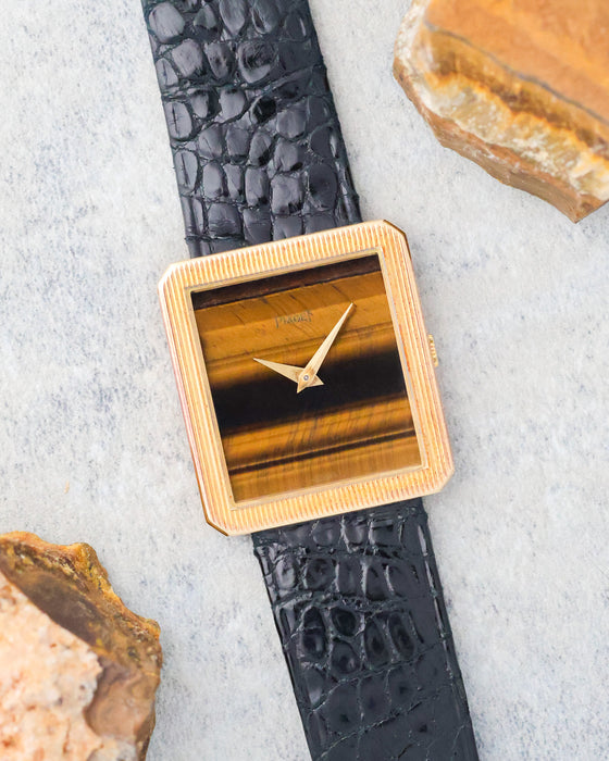 Piaget Protocole Ref. 9154 photographed alongside natural stone, highlighting the colour and banding of its tiger’s eye dial.