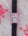 Front view of the Cartier Tank Allongée WB302831 with pink sapphire-set white gold case, Roman numeral dial and black strap.