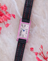 Front view of the Cartier Tank Allongée WB302831 with pink sapphire-set white gold case, Roman numeral dial and black strap.