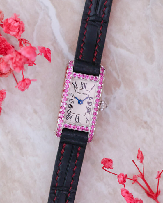 Front view of the Cartier Tank Allongée WB302831 with pink sapphire-set white gold case, Roman numeral dial and black strap.