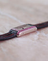 Side profile of the Cartier Tank Allongée highlighting the curved white gold case and pink sapphire-set brancard.
