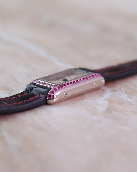 Side profile of the Cartier Tank Allongée highlighting the curved white gold case and pink sapphire-set brancard.