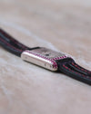 Opposite side profile showing the slim construction and gemstone setting of the Cartier Tank Allongée.