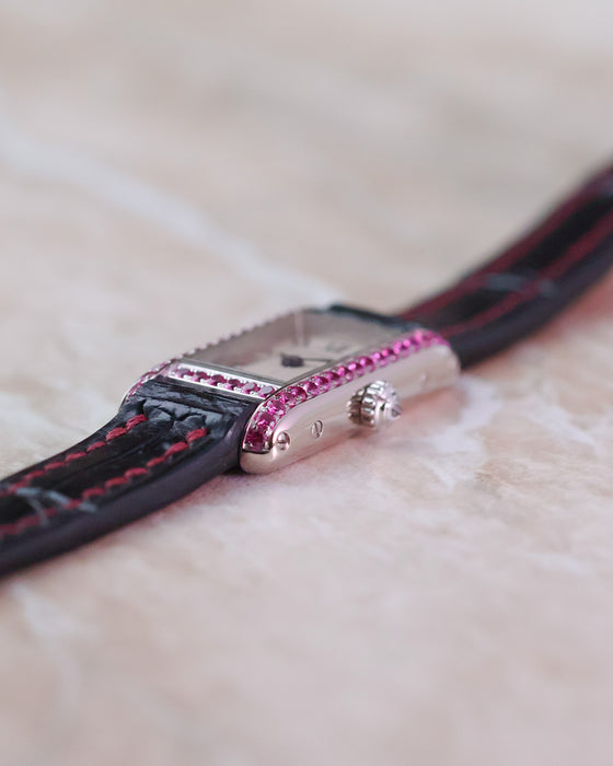 Crown-side profile of the Cartier Tank Allongée with its faceted crown and pink sapphire-set case.