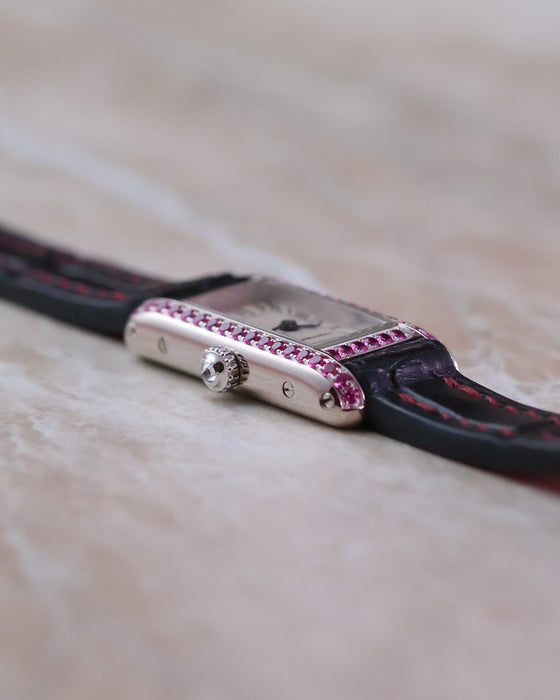 Low-angle view showing the elongated proportions, curved case and crown of the Cartier Tank Allongée.