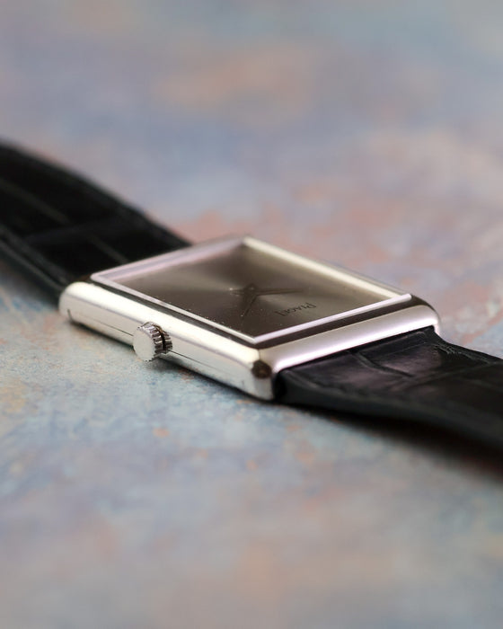 Angled view of the Piaget Ref. 9150 showing its silver dial, dauphine hands and rectangular white gold case.