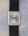 Front view of the Piaget Ref. 9150 with silver sunburst dial, polished dot markers and black leather strap.