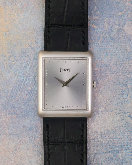Front view of the Piaget Ref. 9150 with silver sunburst dial, polished dot markers and black leather strap.