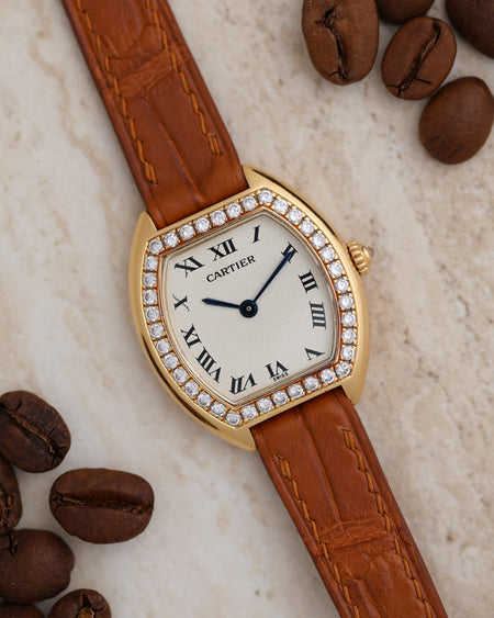 Angled view of the Cartier Tonneau Ref. 1945 showing its factory diamond bezel, Roman numeral dial and blued steel hands.