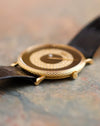 Side profile of the Piaget Ref. 9026 showing its textured 18K yellow gold case, black onyx dial and diamond-set mystery-hour display.