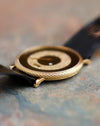 Macro side view of the Piaget Ref. 9026 showing the textured gold case and layered onyx and diamond dial.