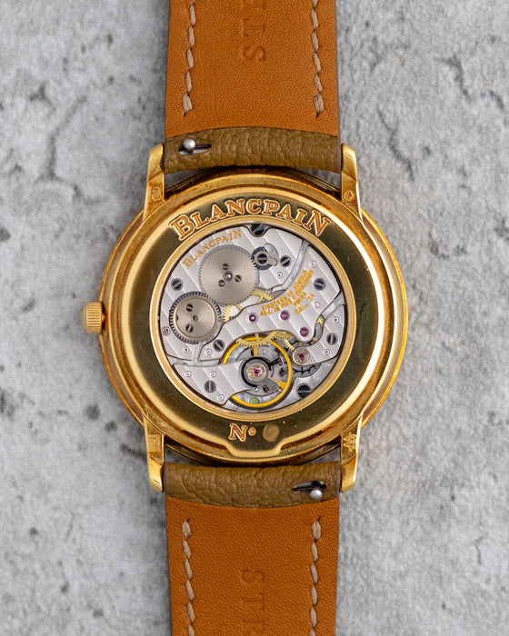 Exhibition caseback of the Blancpain Ref. 0021 showing the manual-winding calibre 21 and engraved yellow-gold caseback.