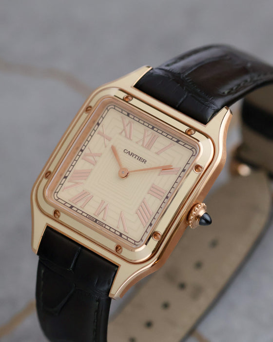Angled view of the Cartier Santos-Dumont WGSA0054 showing its rose-gold case, lacquer detailing and sapphire-set crown.