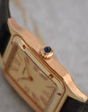 Macro side view of the Cartier Santos-Dumont WGSA0054 showing the brushed rose-gold case and sapphire cabochon crown.