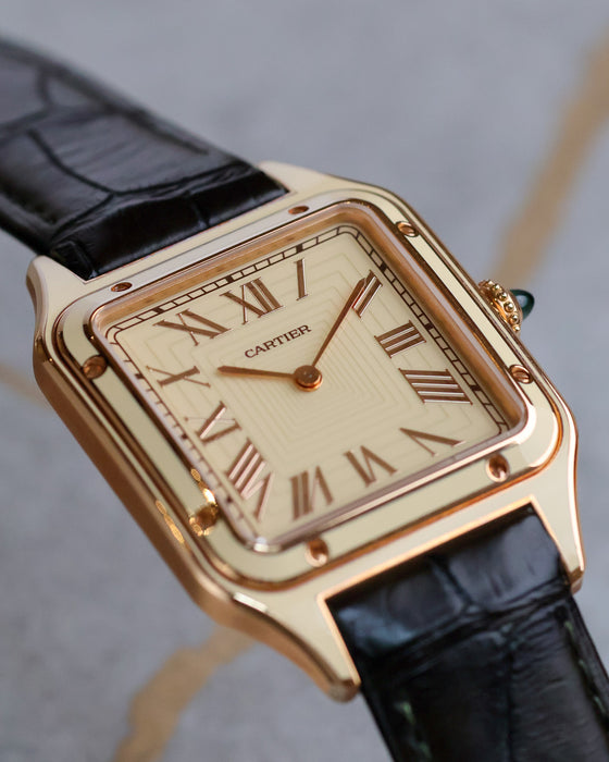 Low-angle close-up of the Cartier Santos-Dumont WGSA0054 showing the layered dial, lacquer bezel and polished rose-gold details.