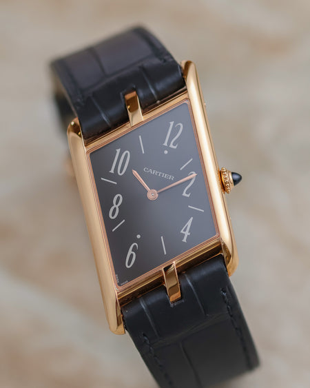 Angled view of the Cartier Tank Asymétrique WGTA0043 showing its diagonal anthracite dial and elongated pink-gold case.