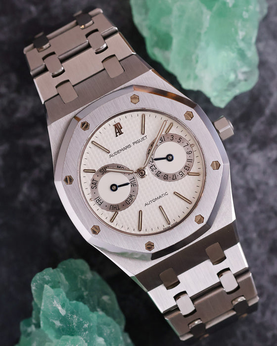 Audemars Piguet Royal Oak 25572ST photographed with green mineral specimens highlighting its white calendar dial.