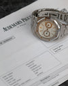 Audemars Piguet Royal Oak 25572ST displayed alongside Audemars Piguet service documentation dated March 2022.
