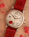 Angled view of the Chopard Happy Sport Cortina 50th Anniversary showing its white guilloché dial, mobile diamonds and red heart.