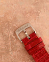 Signed Chopard stainless-steel pin buckle fitted to the original red alligator leather strap.
