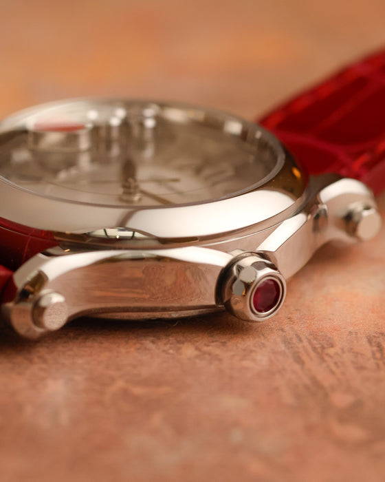 Side profile of the Chopard Happy Sport showing its polished stainless-steel case, articulated lug and gem-set crown.